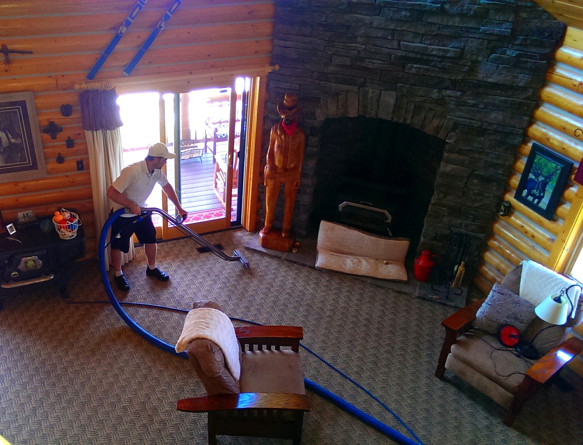 ACDC technician truck-mount extracting carpet in a Cache Valley log home