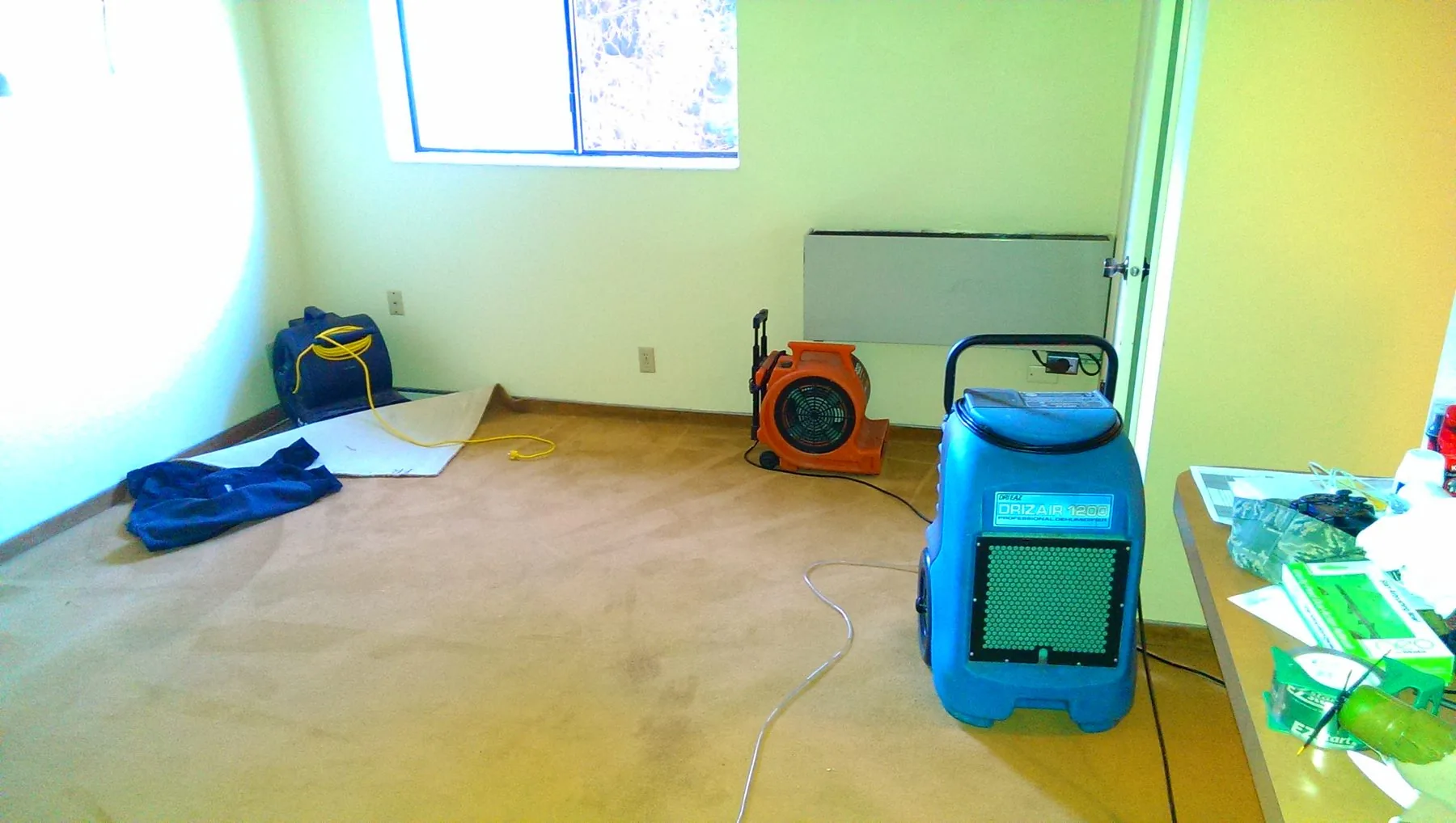 Dri-Eaz DrizAir 1200 dehumidifier and air movers on a water job