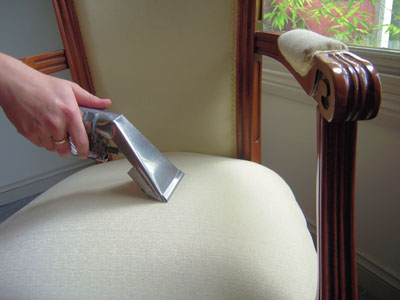 Upholstery wand cleaning a fabric sofa