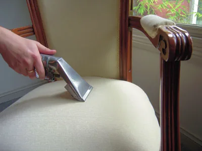 Upholstery wand cleaning a fabric sofa